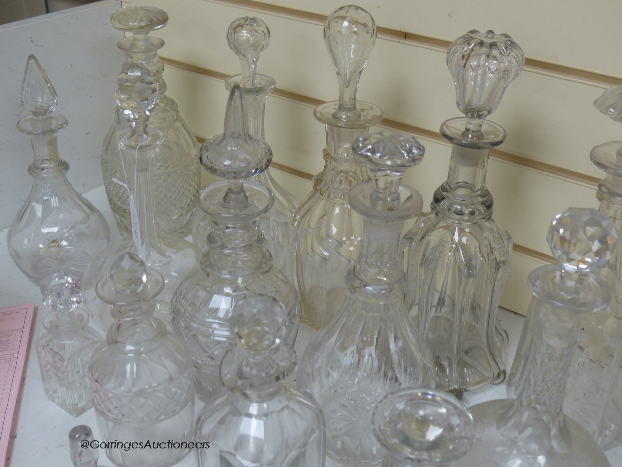 A collection of cut glass decanters, stoppers, etc.